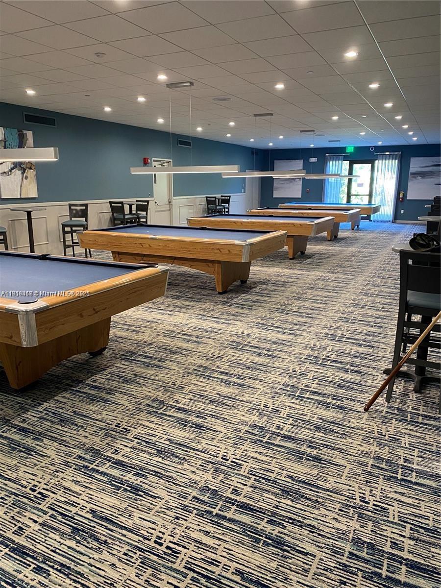 6935 Huntington Lane, Unit 107 Delray Beach, FL 33446 - Photo 21 of 23 a room with lots of furniture and a table