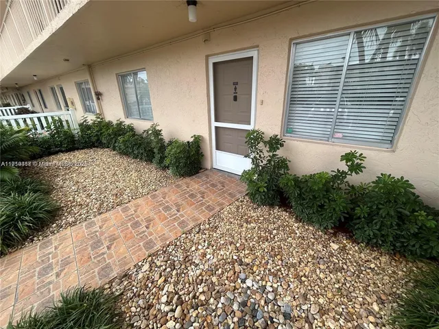 wooden floor in an empty room with a large window