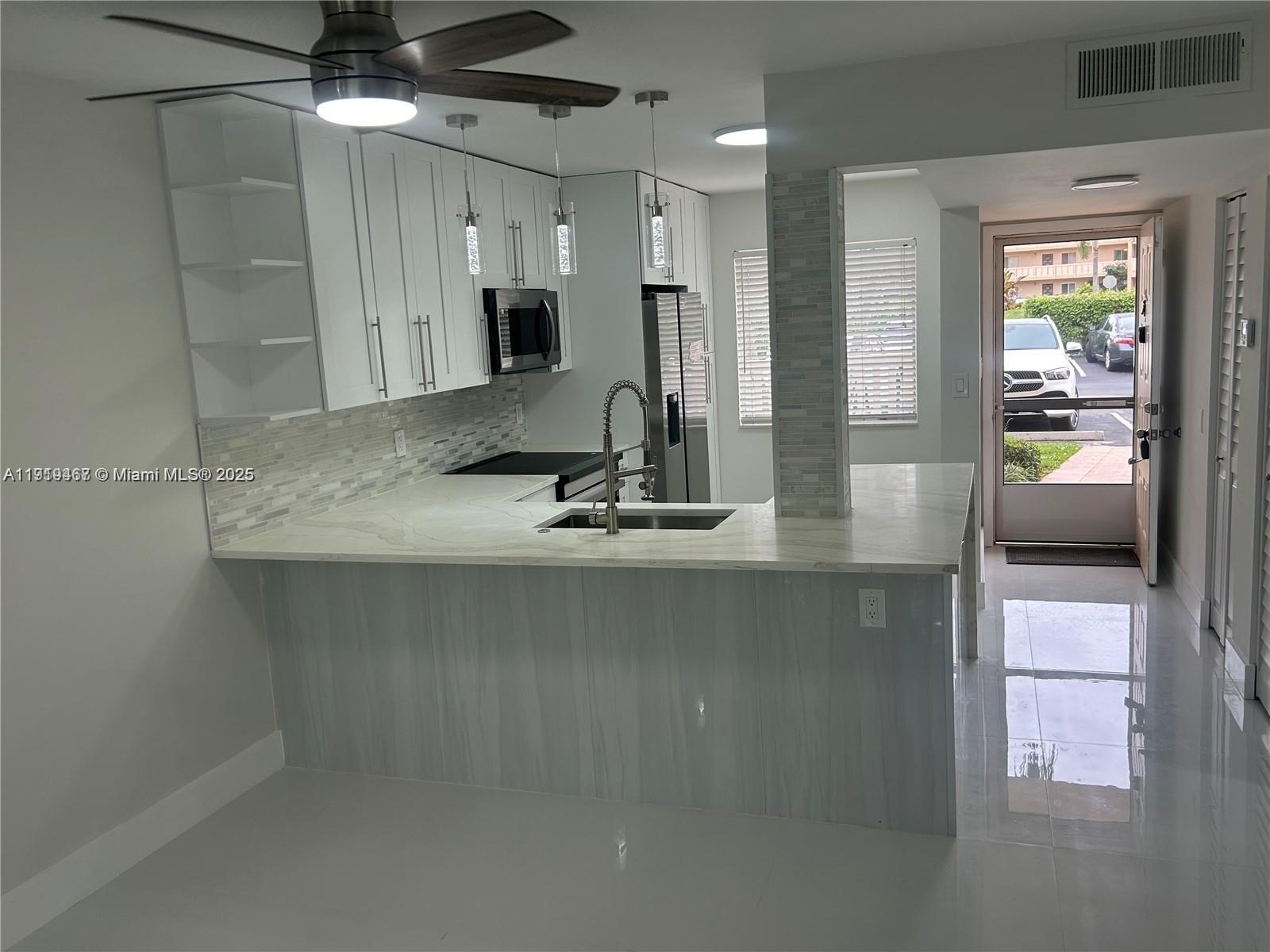 6935 Huntington Lane, Unit 107 Delray Beach, FL 33446 - Photo 3 of 23 a view of a room with gym equipment