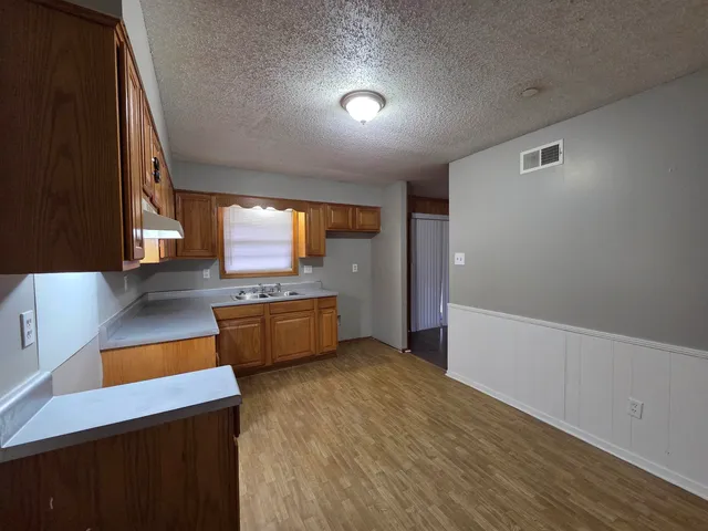a kitchen with stainless steel appliances granite countertop a stove and a refrigerator