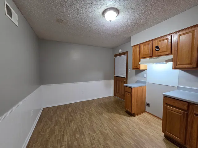 a kitchen with a stove a sink and a microwave