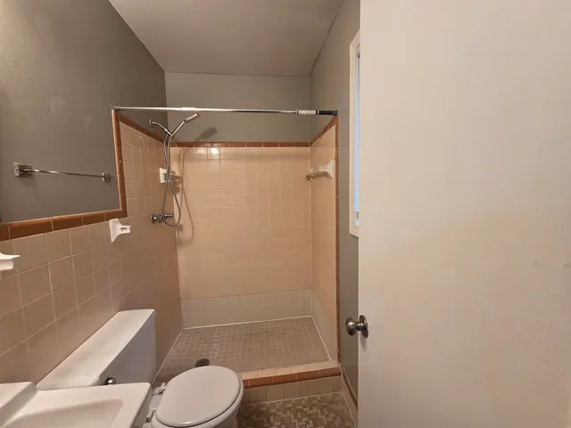 a bathroom with a light fixture and a mirror