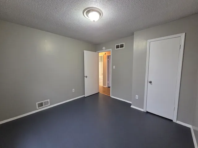 an empty room with a empty space and windows