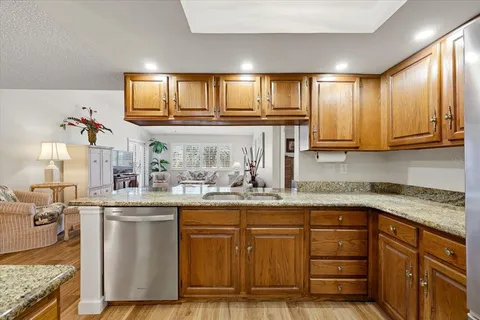 a kitchen with stainless steel appliances granite countertop a sink and cabinets