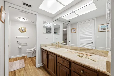 a bathroom with a toilet a sink and shower