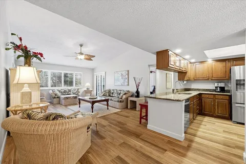a living room with granite countertop furniture and kitchen