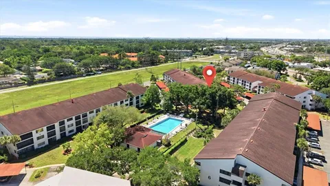 an aerial view of a house with a garden and lake view