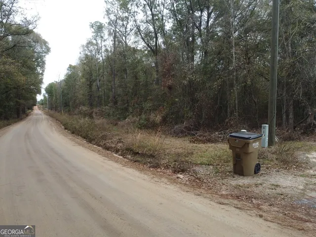 a view of a water fountain and trees