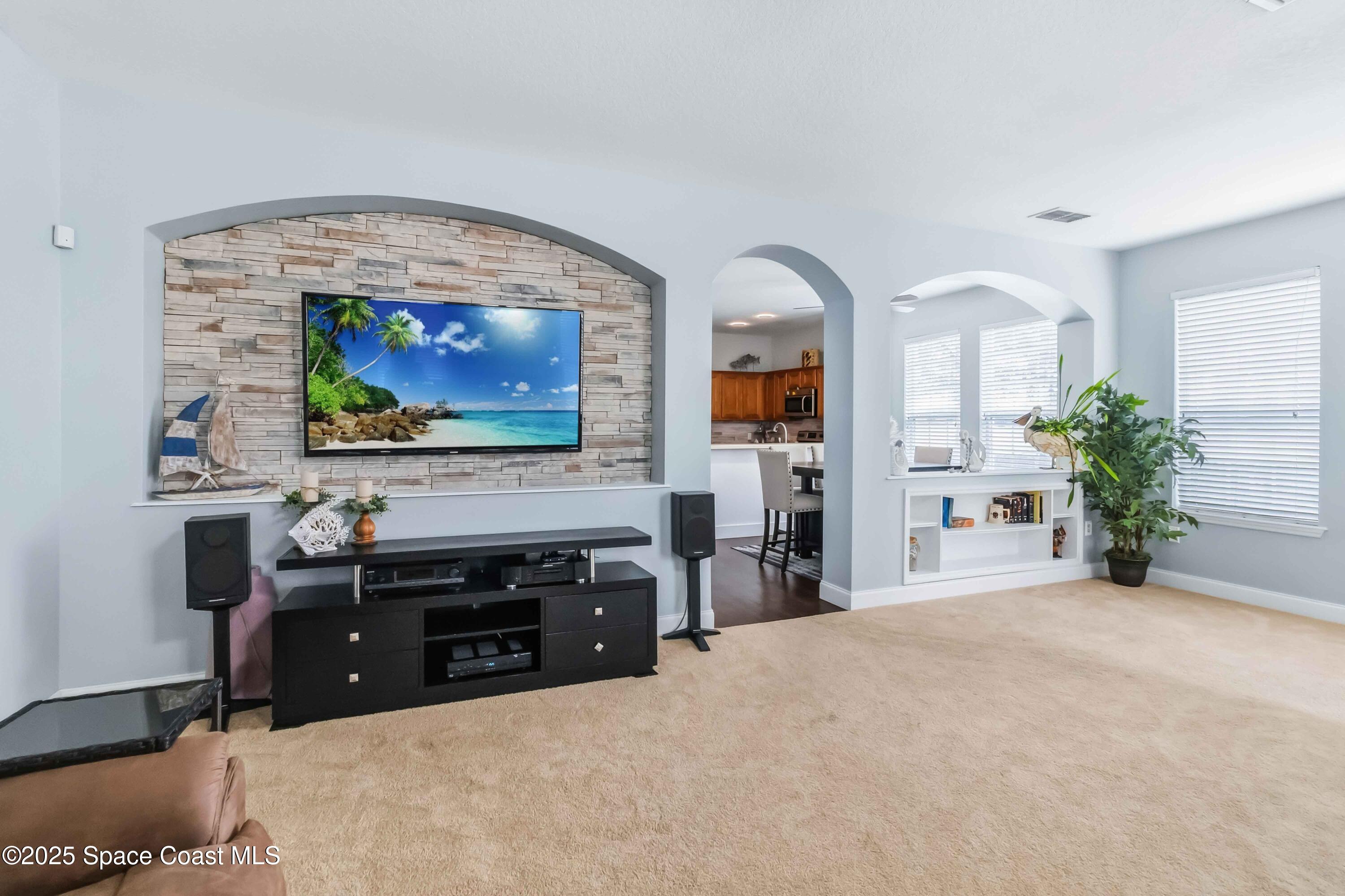 3607 Clay Brick Road Harmony, FL 34773 - Photo 11 of 72 a living room with furniture and a flat screen tv