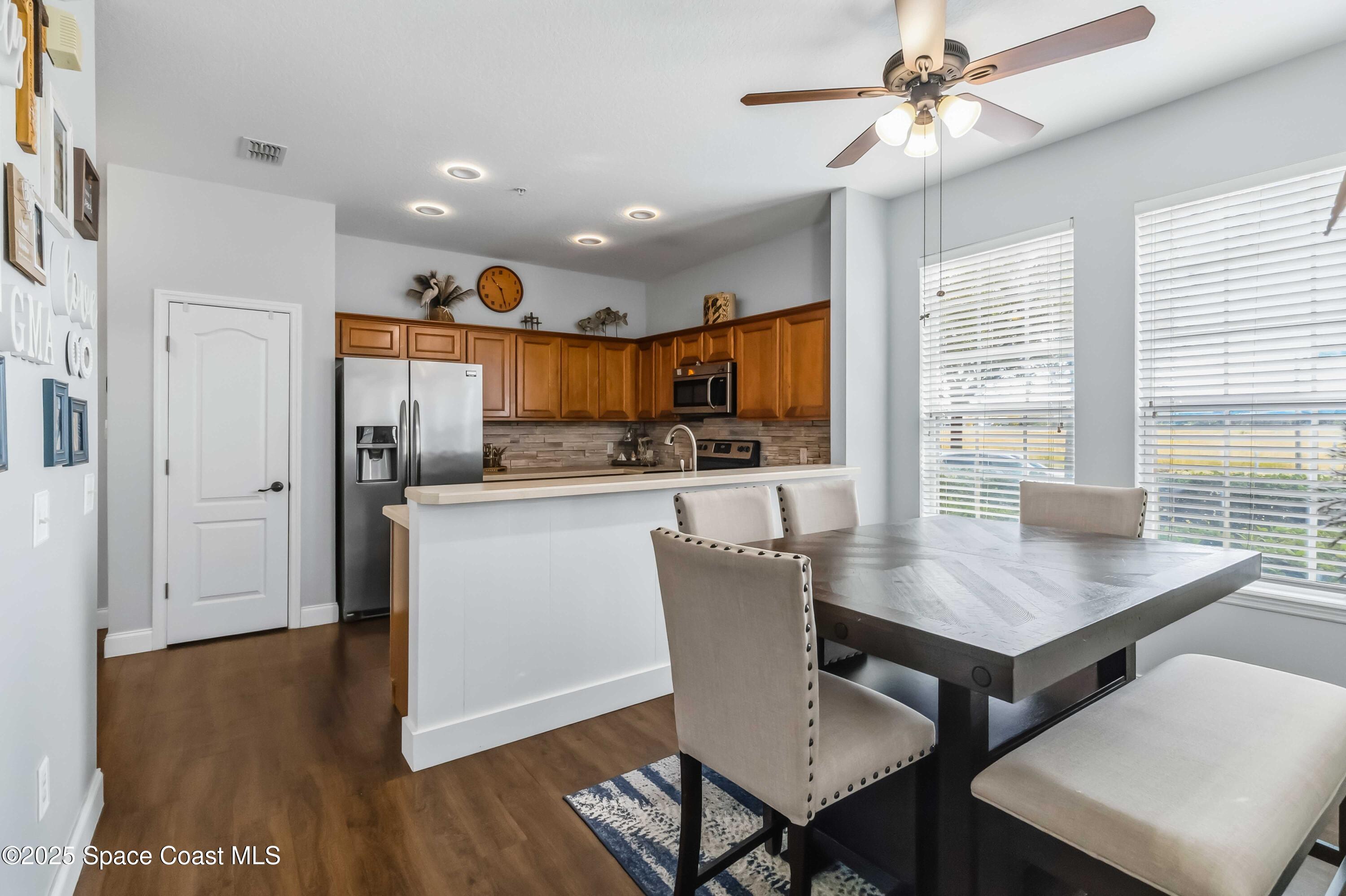 3607 Clay Brick Road Harmony, FL 34773 - Photo 12 of 72 a kitchen with a table chairs refrigerator and microwave