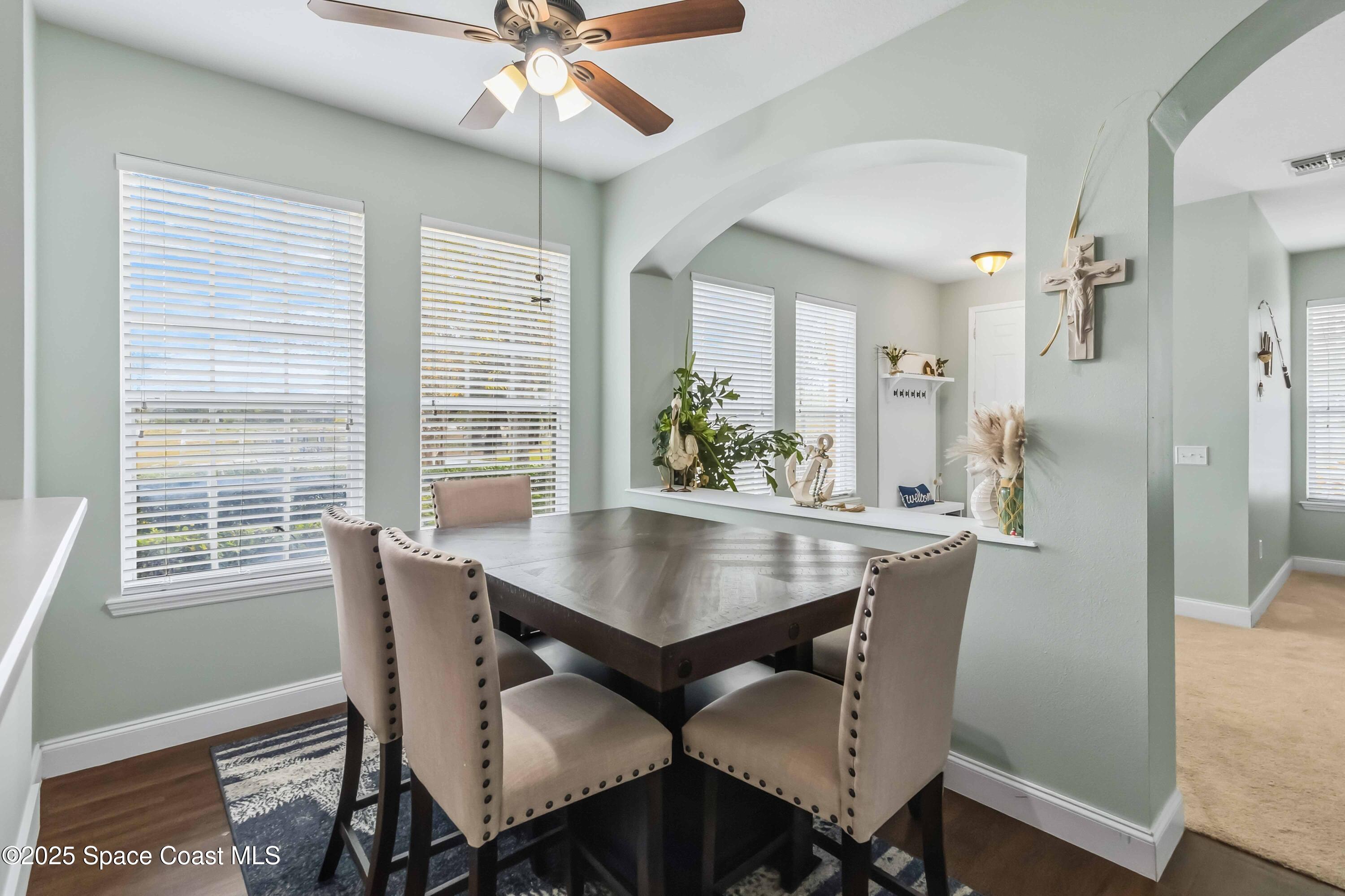 3607 Clay Brick Road Harmony, FL 34773 - Photo 13 of 72 a view of a dining room with furniture window and wooden floor