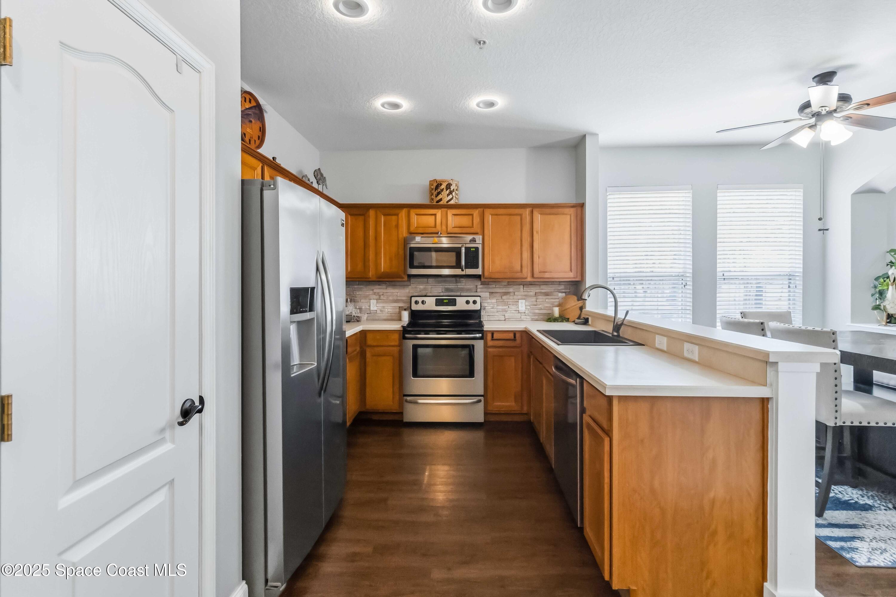 3607 Clay Brick Road Harmony, FL 34773 - Photo 17 of 72 a kitchen with stainless steel appliances granite countertop a stove a sink and a refrigerator