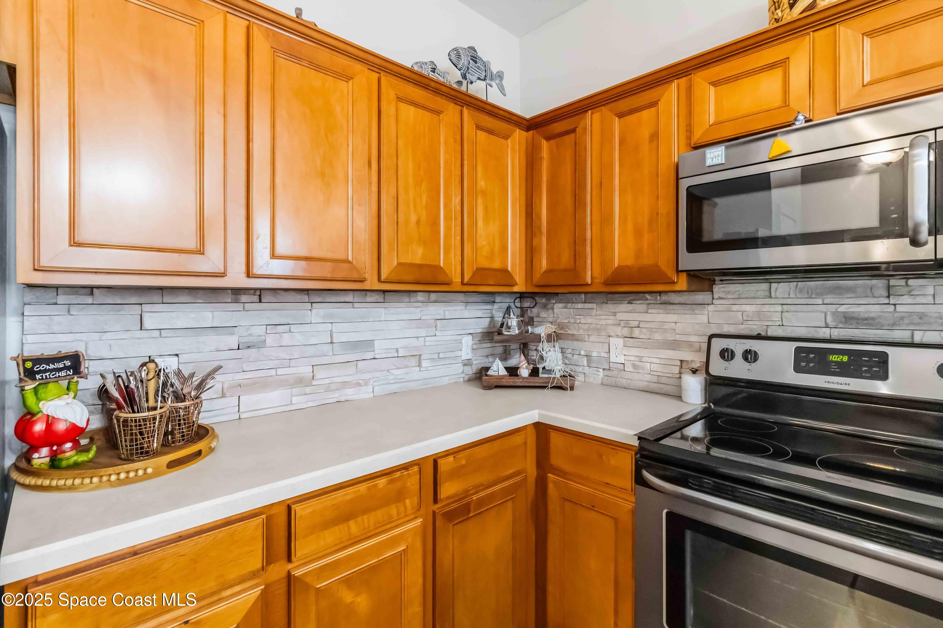 3607 Clay Brick Road Harmony, FL 34773 - Photo 20 of 72 a kitchen with stainless steel appliances a stove a sink and a microwave