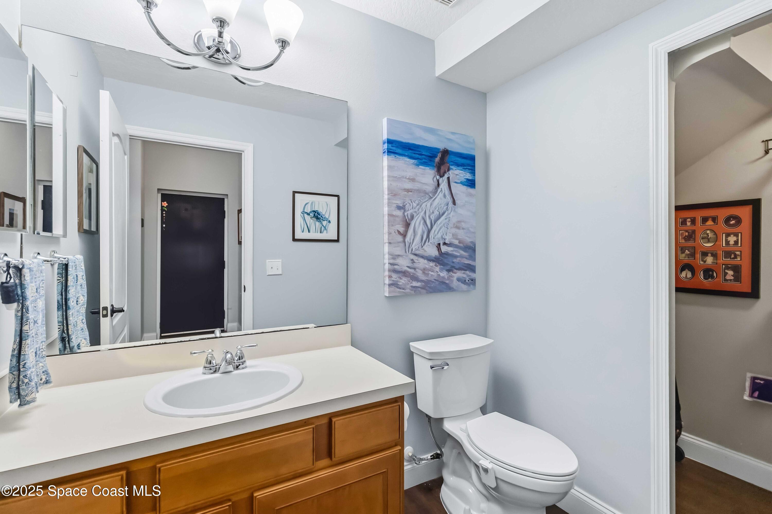 3607 Clay Brick Road Harmony, FL 34773 - Photo 23 of 72 a bathroom with a toilet a sink and a mirror
