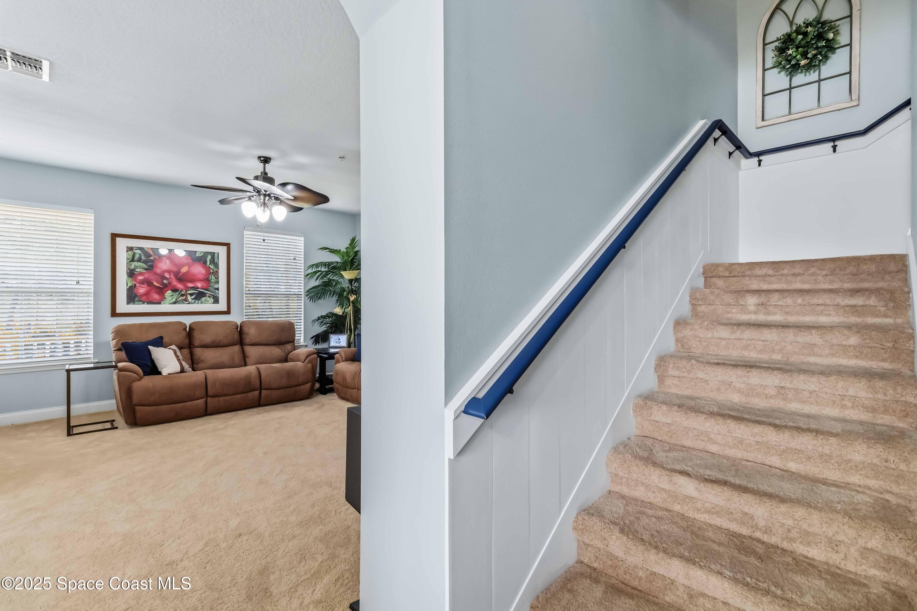 3607 Clay Brick Road Harmony, FL 34773 - Photo 25 of 72 a living room with furniture and a stairs