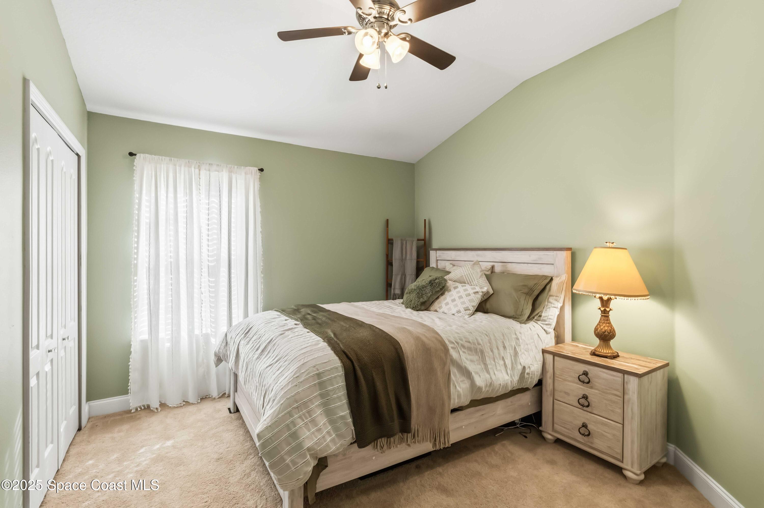 3607 Clay Brick Road Harmony, FL 34773 - Photo 29 of 72 a bedroom with a bed and a chandelier