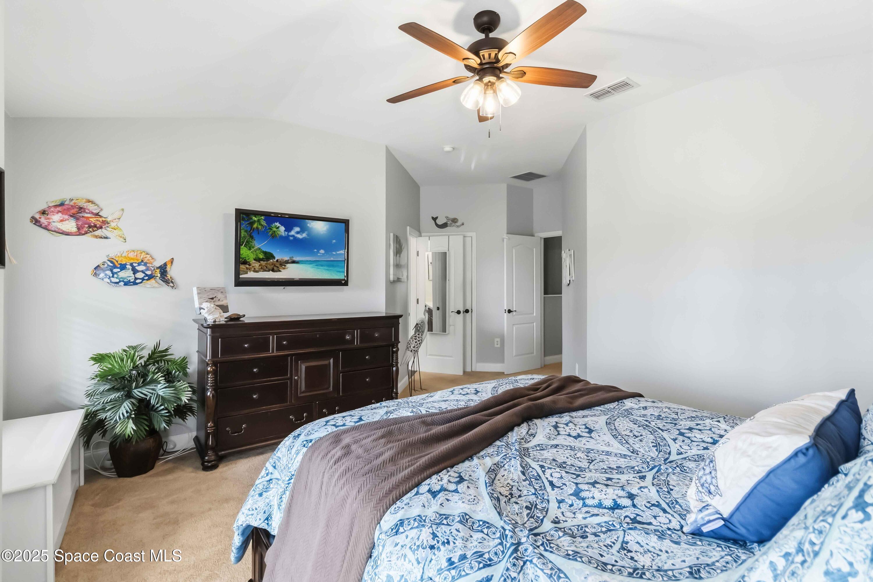 3607 Clay Brick Road Harmony, FL 34773 - Photo 34 of 72 a bedroom with a bed and a chandelier
