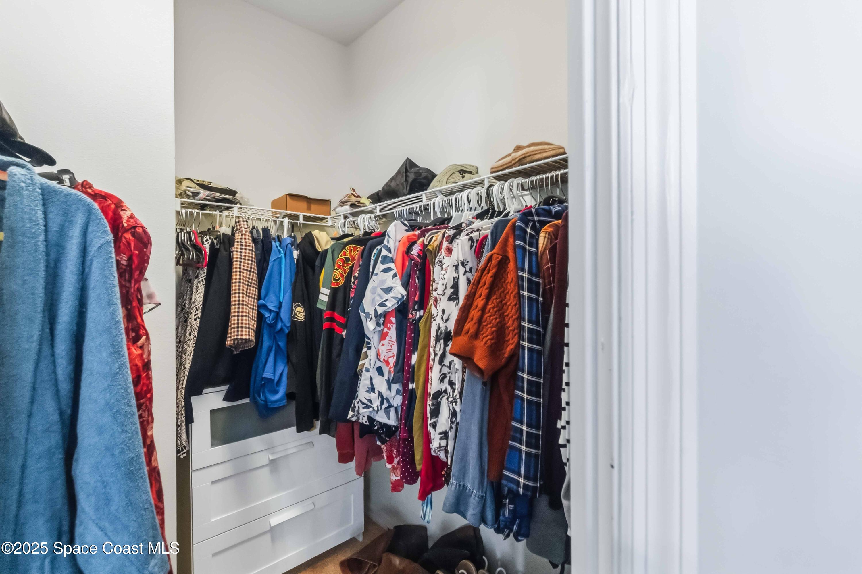 3607 Clay Brick Road Harmony, FL 34773 - Photo 35 of 72 a view of walk in closet with clothes