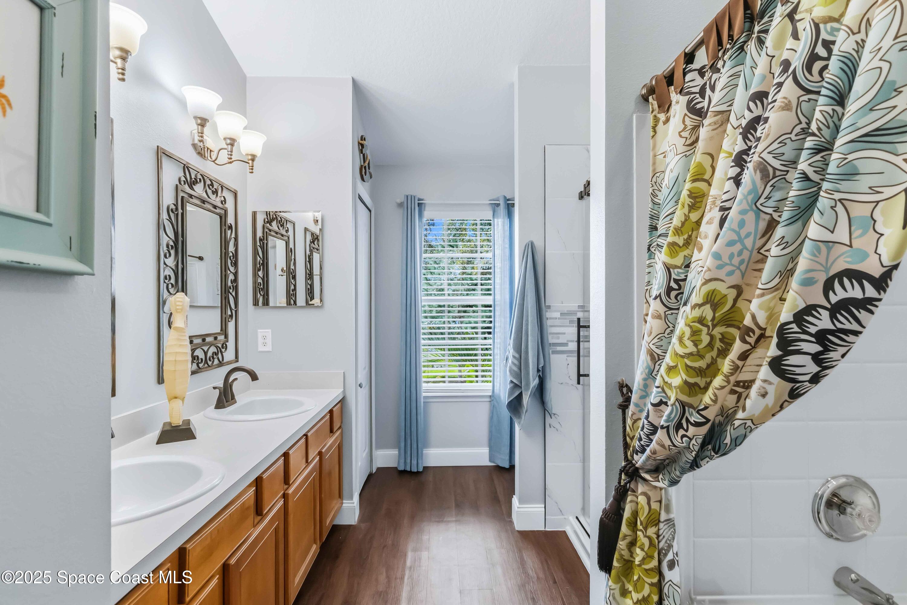 3607 Clay Brick Road Harmony, FL 34773 - Photo 37 of 72 a spacious bathroom with a double vanity sink and a mirror