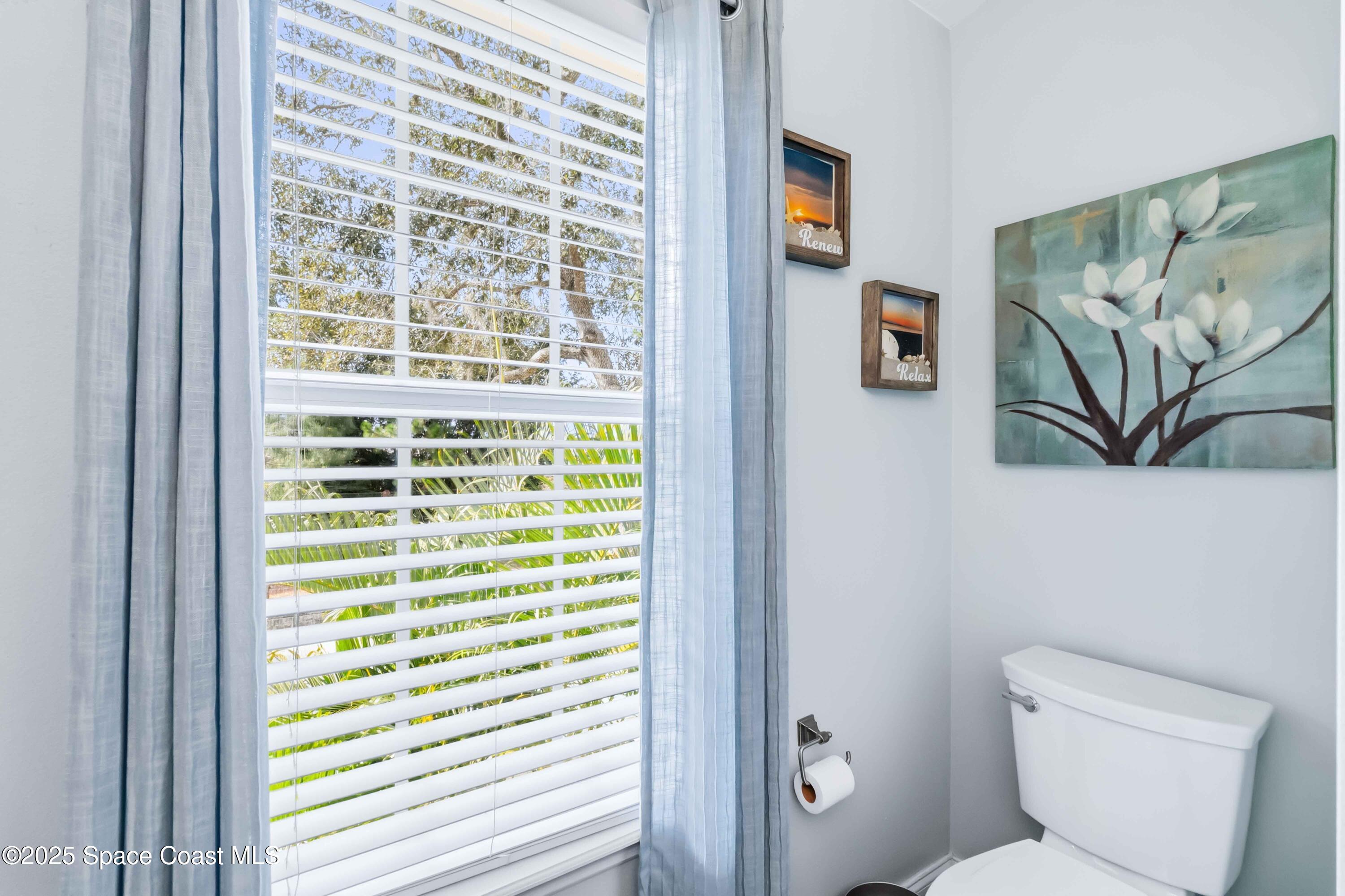 3607 Clay Brick Road Harmony, FL 34773 - Photo 40 of 72 a bathroom with a toilet and a shower curtain