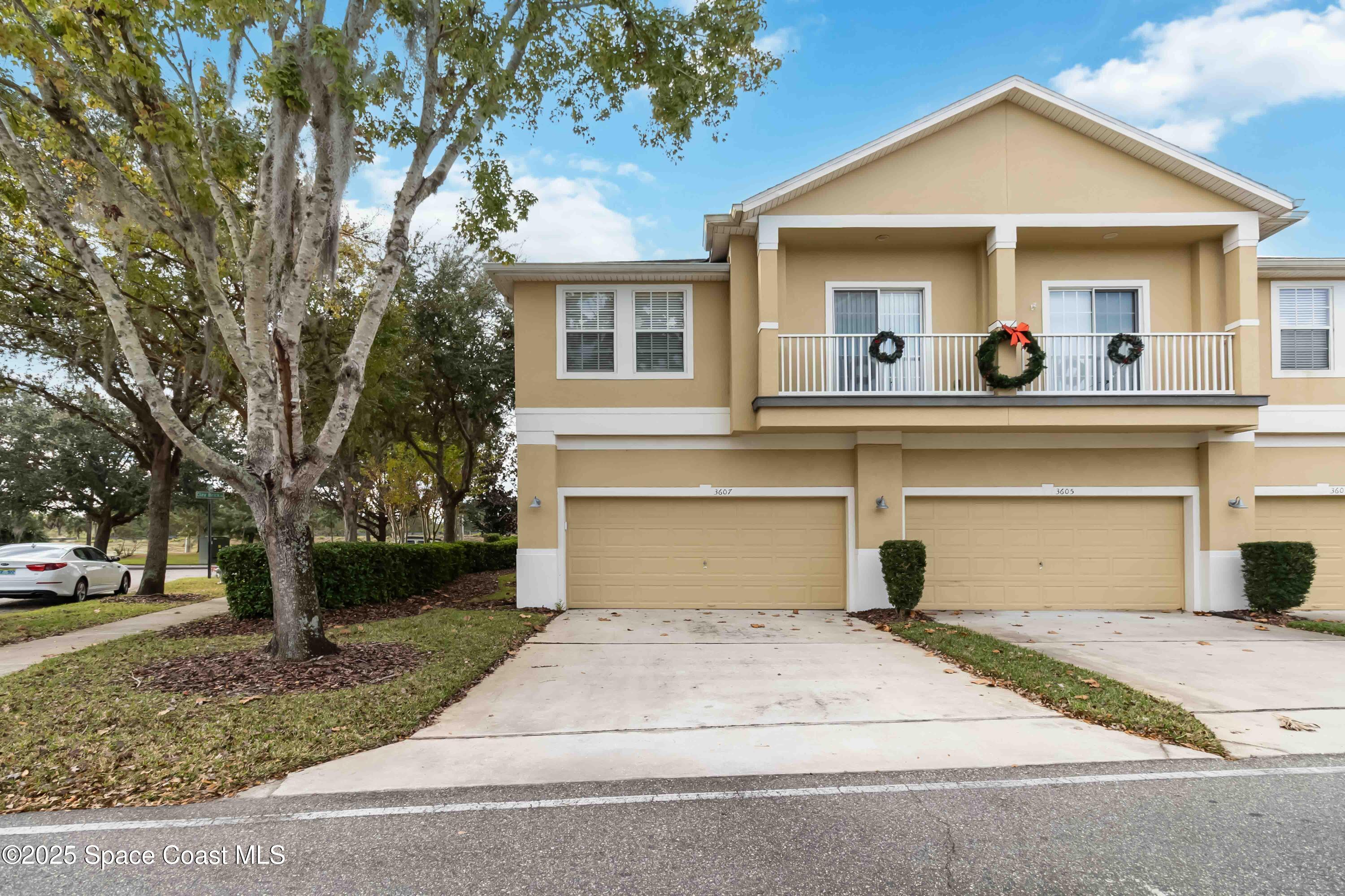3607 Clay Brick Road Harmony, FL 34773 - Photo 46 of 72 a front view of a house with a yard and garage