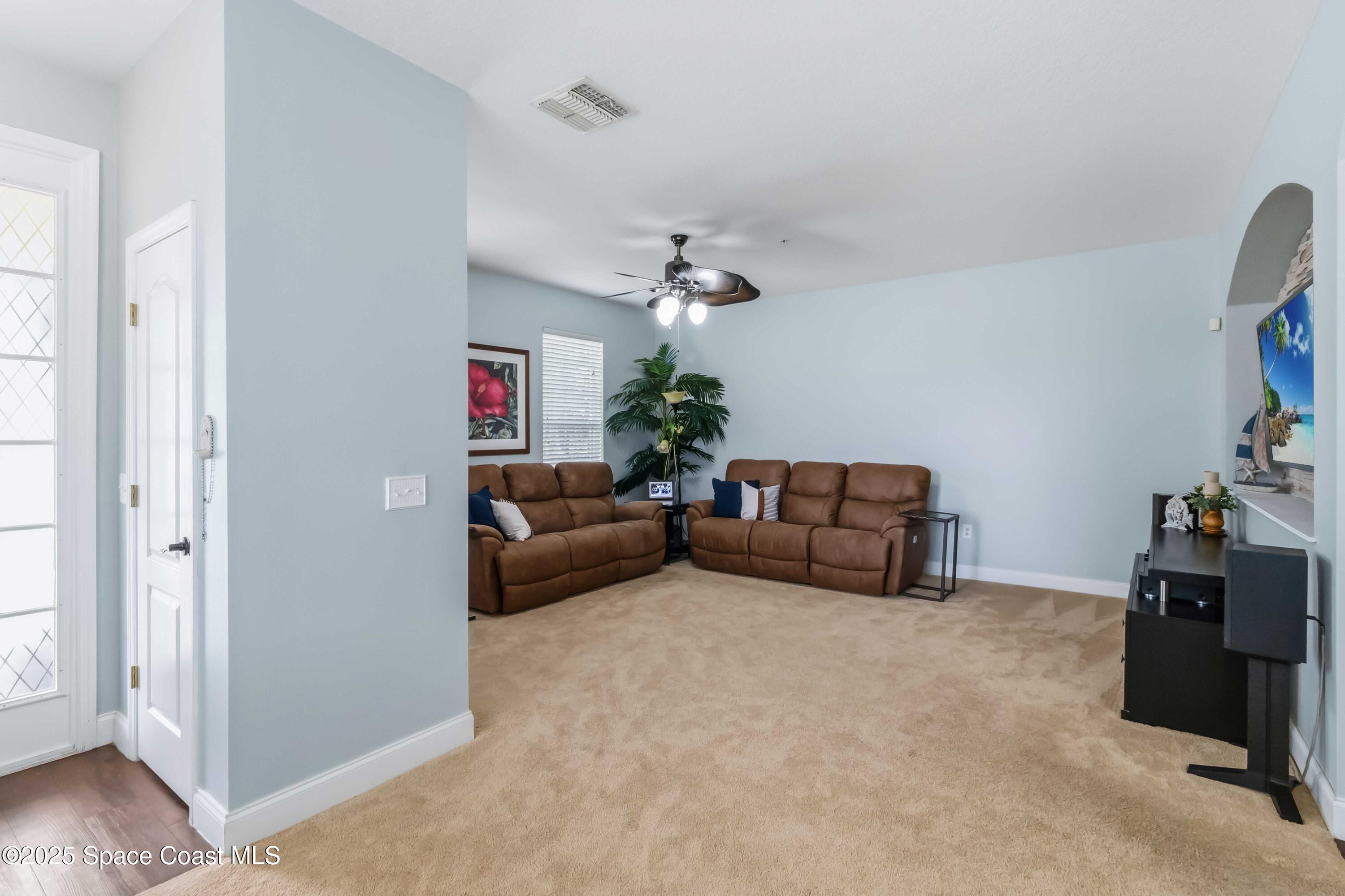 3607 Clay Brick Road Harmony, FL 34773 - Photo 8 of 72 a living room with furniture and a chandelier