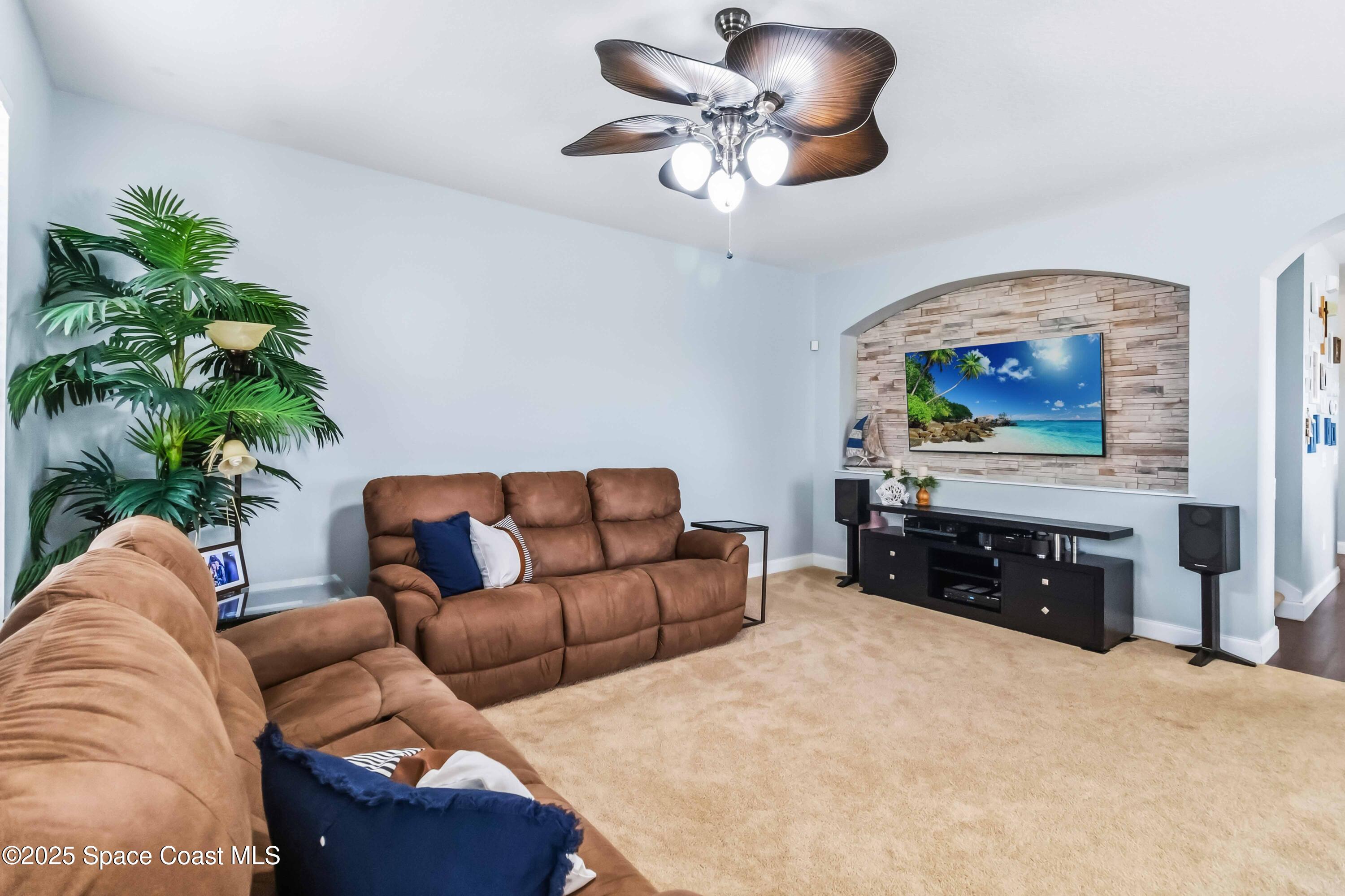 3607 Clay Brick Road Harmony, FL 34773 - Photo 10 of 72 a living room with furniture a chandelier and a rug