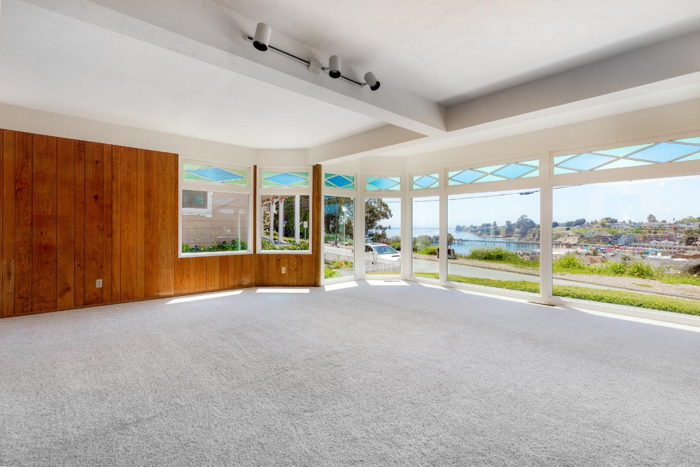 106 Cliff Avenue Capitola, CA 95010 - Photo 7 of 30 an empty room with floor to ceiling windows and pool table
