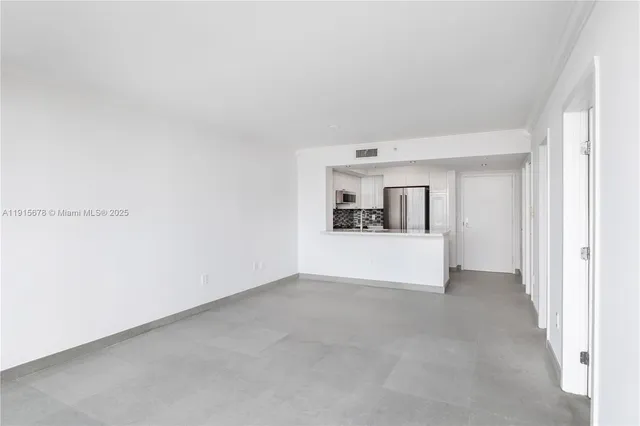 a kitchen with stainless steel appliances a refrigerator sink stove microwave and cabinets