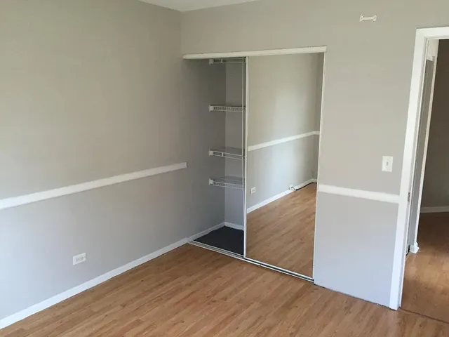 an empty room with wooden floor