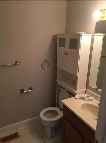 a bathroom with a sink toilet and mirror