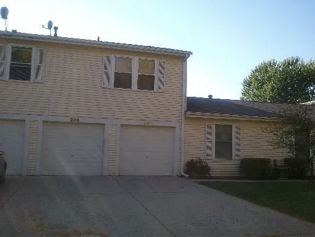 206 Sunset Court Vernon Hills, IL 60061 - Photo 2 of 13 a front view of a house with a yard and garage