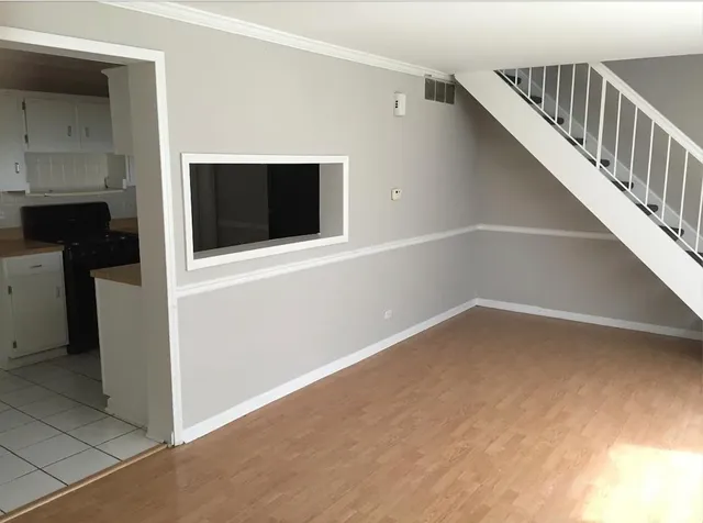 a view of an empty room with a fireplace and a window