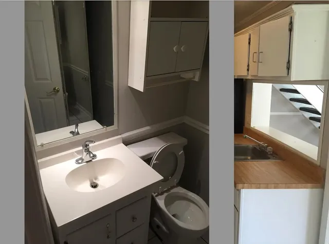 a bathroom with a toilet sink and mirror