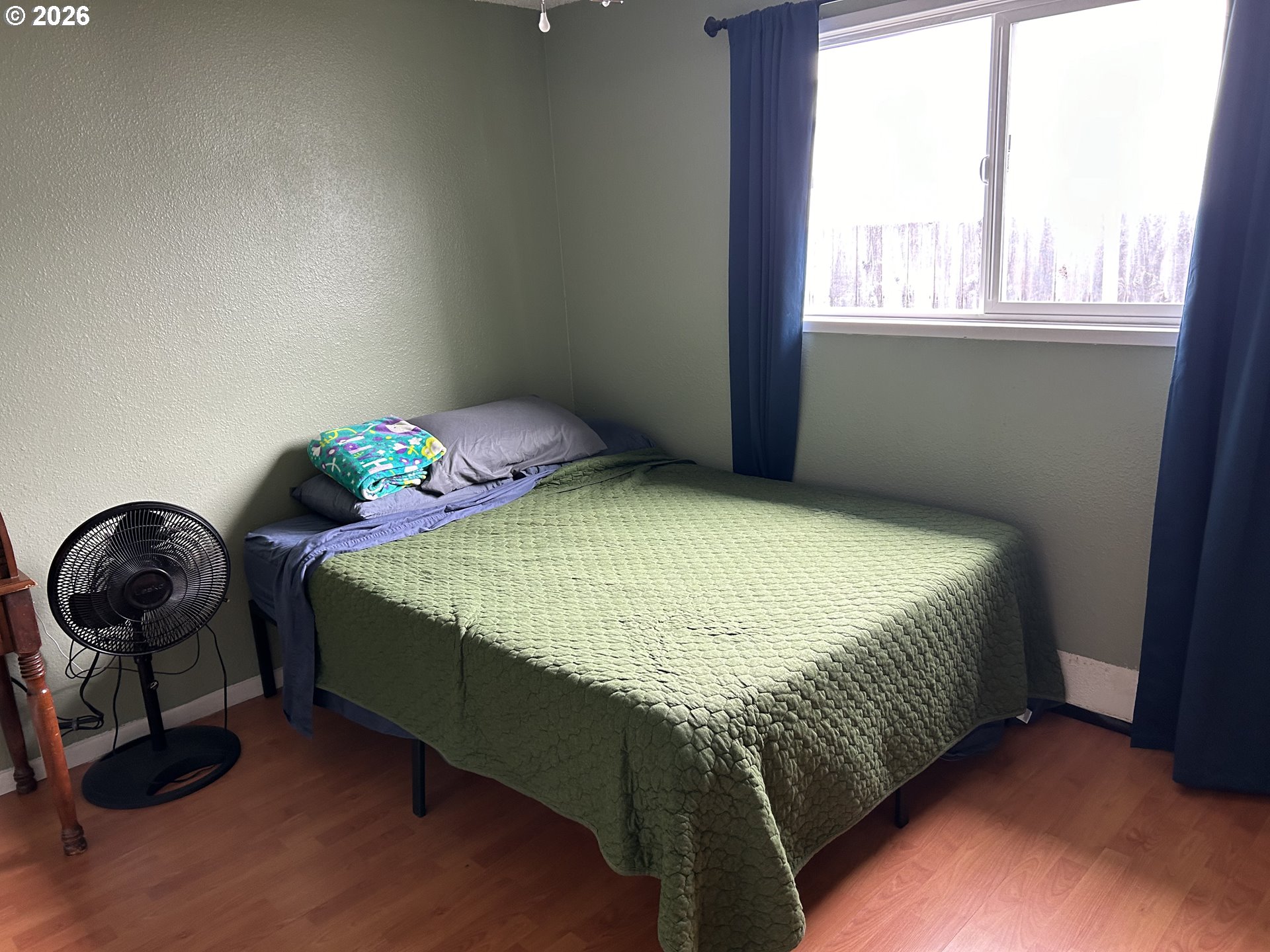 938 North 8th Street Reedsport, OR 97467 - Photo 15 of 16 a bedroom with a bed and a window