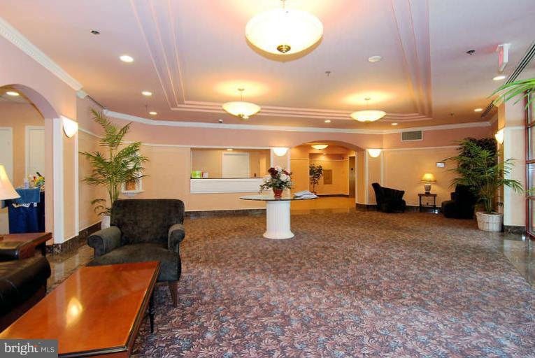 24 Courthouse Square, Unit 907 Rockville, MD 20850 - Photo 22 of 30 a lobby with furniture and a chandelier