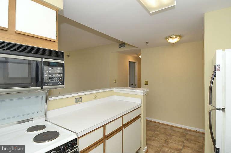 24 Courthouse Square, Unit 907 Rockville, MD 20850 - Photo 6 of 30 a bathroom with a sink and a mirror