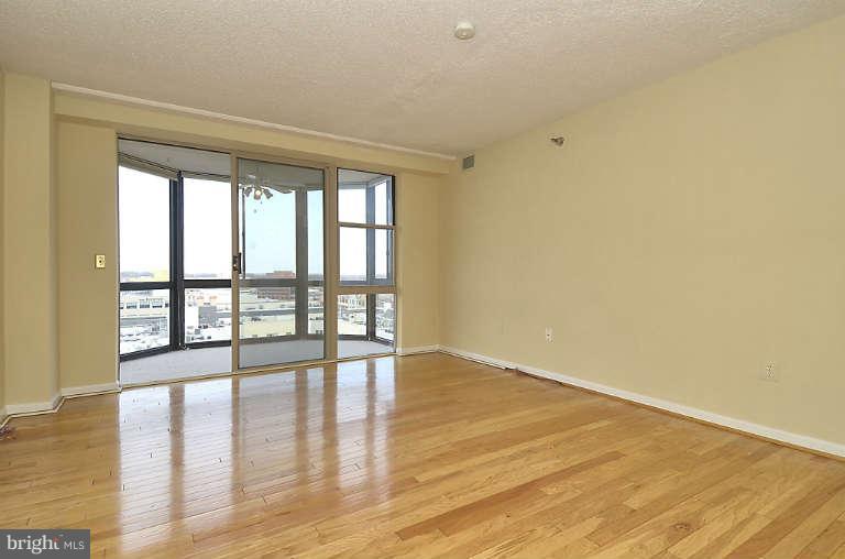 24 Courthouse Square, Unit 907 Rockville, MD 20850 - Photo 8 of 30 wooden floor in an empty room with a window