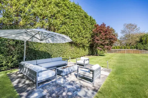 a view of a patio with couches under an umbrella