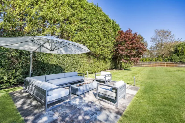 a view of a patio with couches under an umbrella