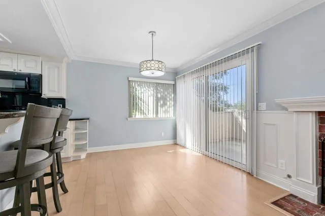 a kitchen with stainless steel appliances granite countertop a refrigerator a sink a stove and white cabinets