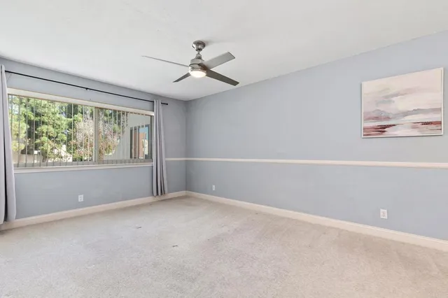 a bathroom with a granite countertop sink a toilet a mirror and shower