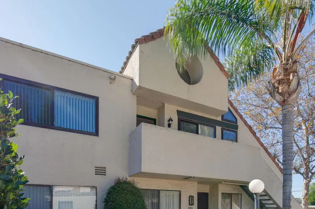 an empty room with windows and fireplace