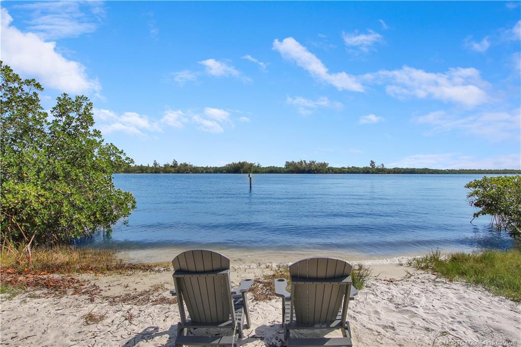 5323 Southeast Miles Grant Road, Unit 206 Stuart, FL 34997 - Photo 19 of 20 a view of a lake from a yard