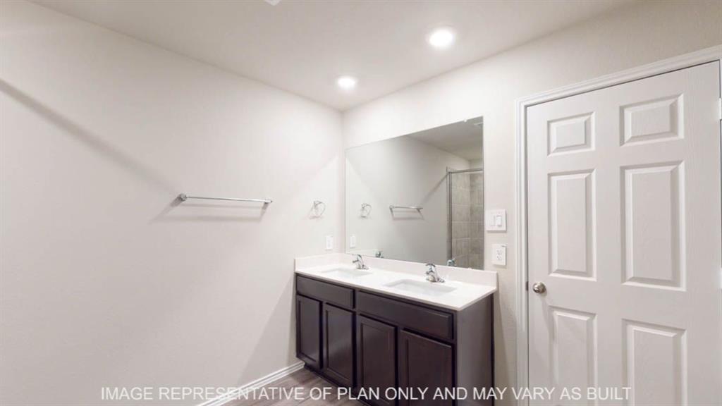 10317 Altair Drive Waco, TX 76708 - Photo 14 of 19 Dual vanity with dark wood-finish cabinetry, white countertop, and integrated sinks