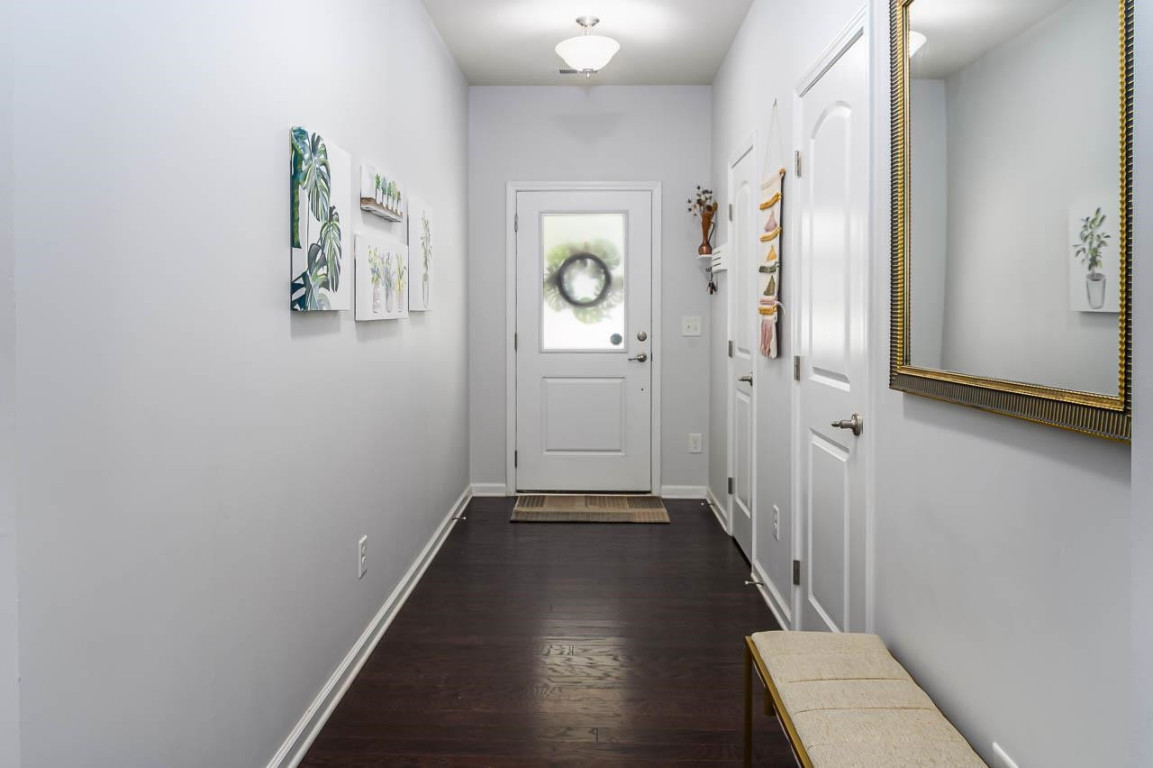 68 Argonaut Drive Durham, NC 27705 - Photo 14 of 29 a view of a hallway with wooden floor and a bathroom