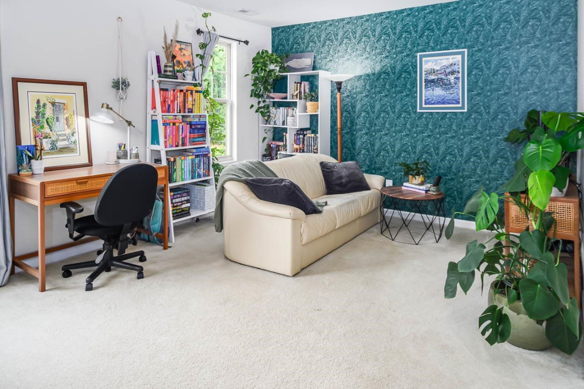 68 Argonaut Drive Durham, NC 27705 - Photo 19 of 29 a living room with furniture and a bookshelf