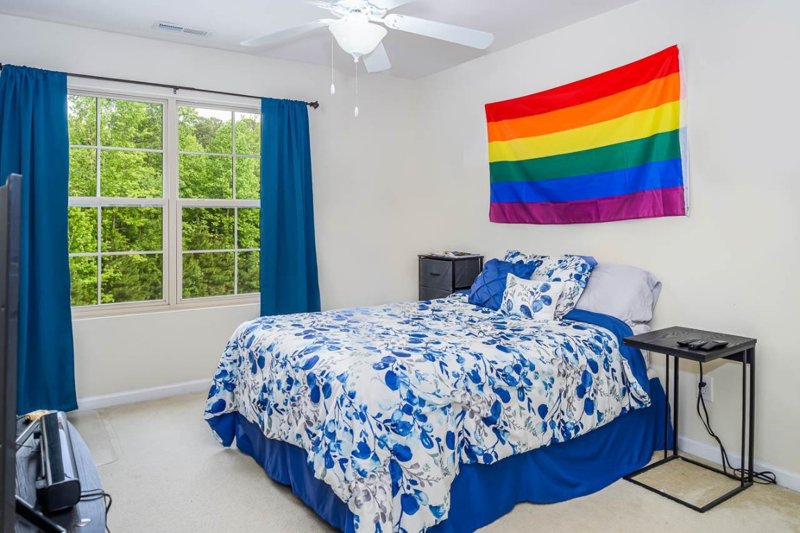 68 Argonaut Drive Durham, NC 27705 - Photo 24 of 29 a bedroom with a bed and a painting on the wall