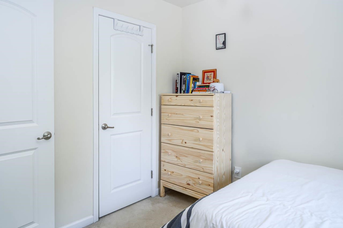 68 Argonaut Drive Durham, NC 27705 - Photo 26 of 29 a bedroom with a bed and cabinets
