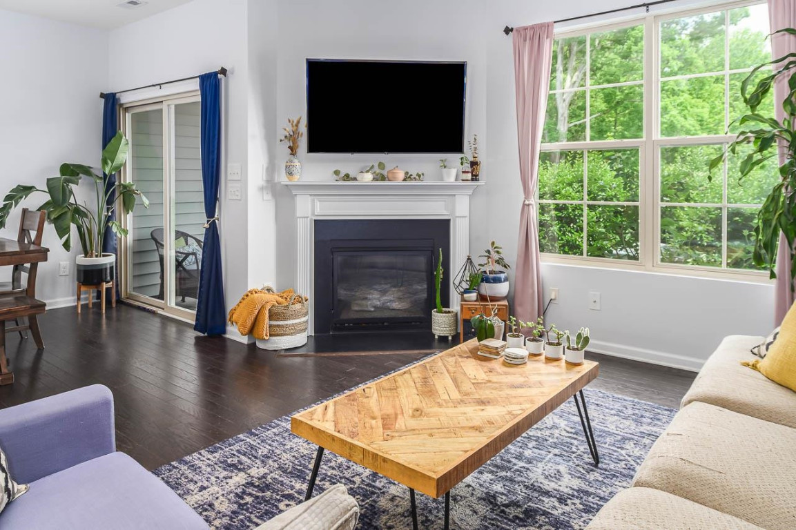 68 Argonaut Drive Durham, NC 27705 - Photo 6 of 29 a living room with furniture a flat screen tv and a fireplace